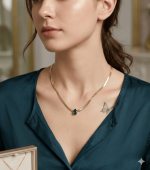 Elegant Gold Herringbone Necklace with Teardrop Emerald and White Pendant
